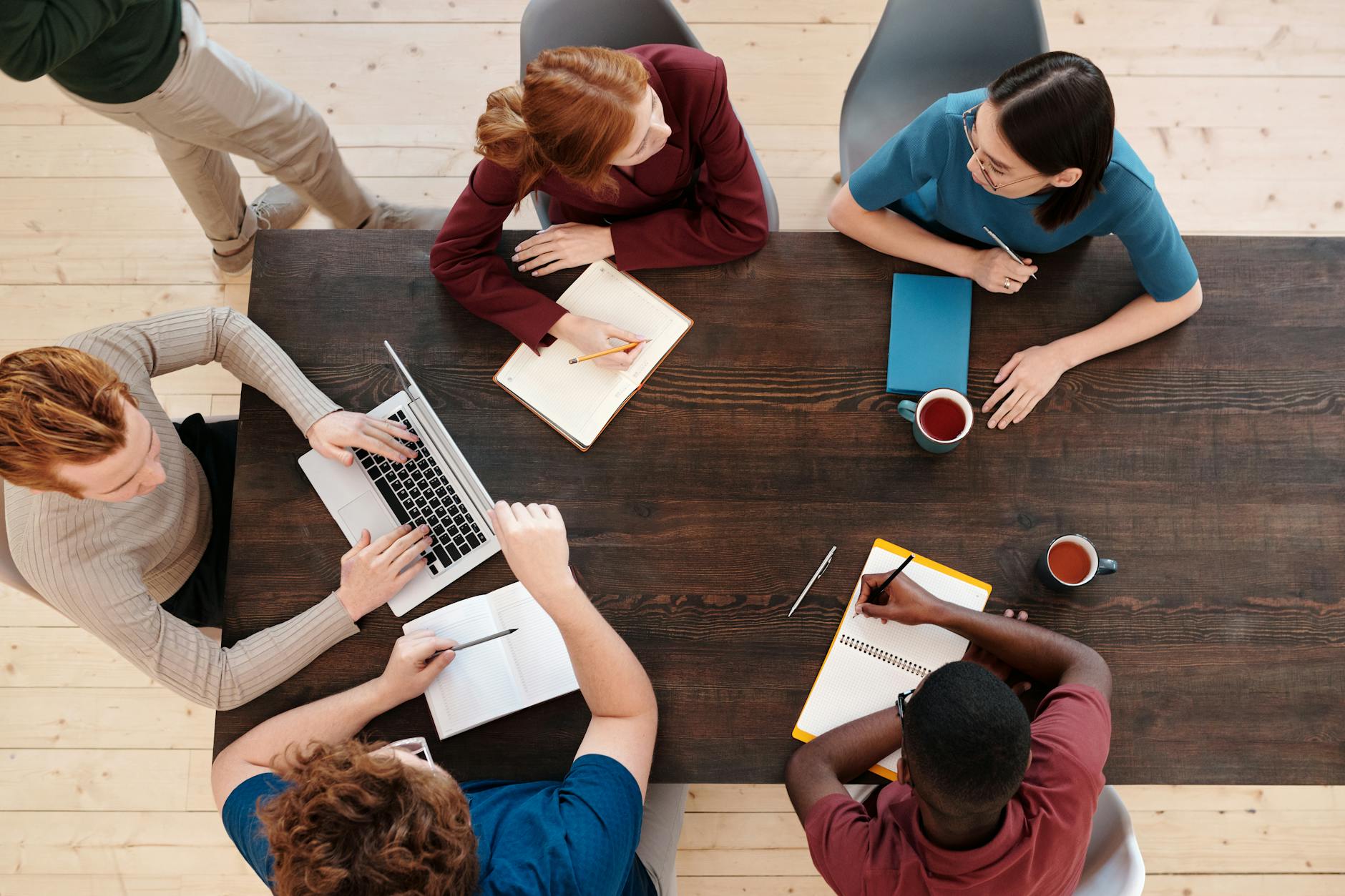employees sitting on the chair in front of the table while having a meeting